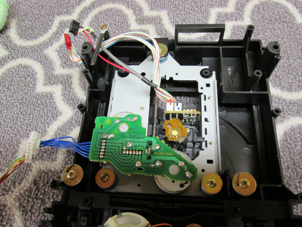 View of CD drive mechanism showing circuits, motors, and more